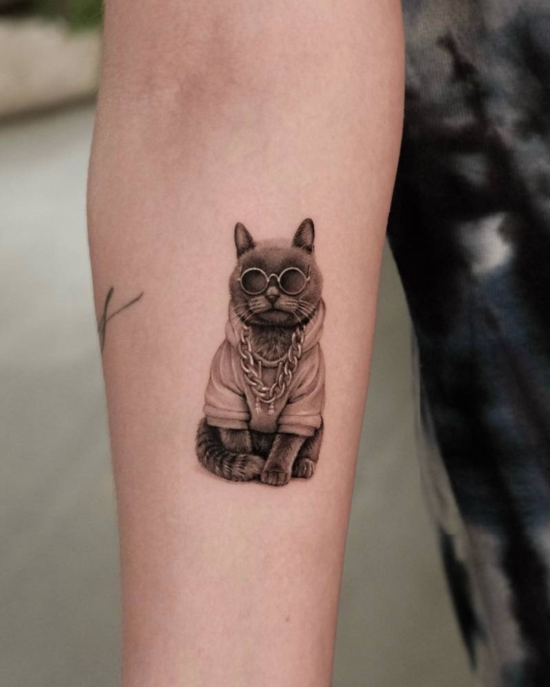 Cool cat tattoo in micro-realistic style located on the inner forearm.