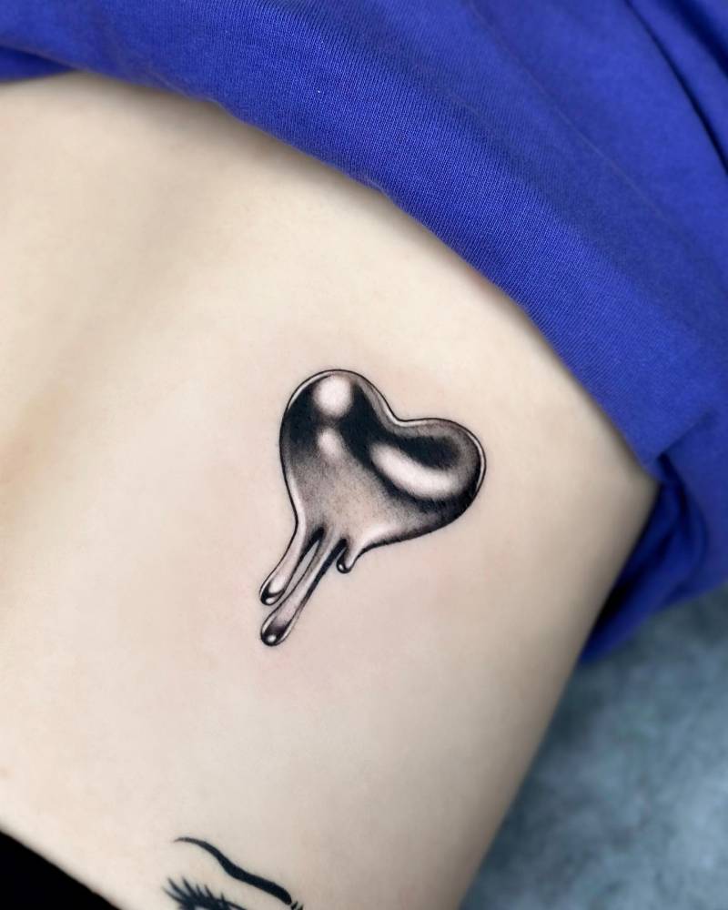 Chrome heart tattoo located on the back.
