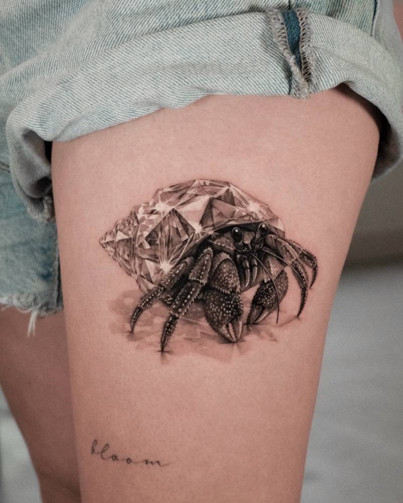 Diamond hermit crab tattoo located on the thigh, micro-realistic style.