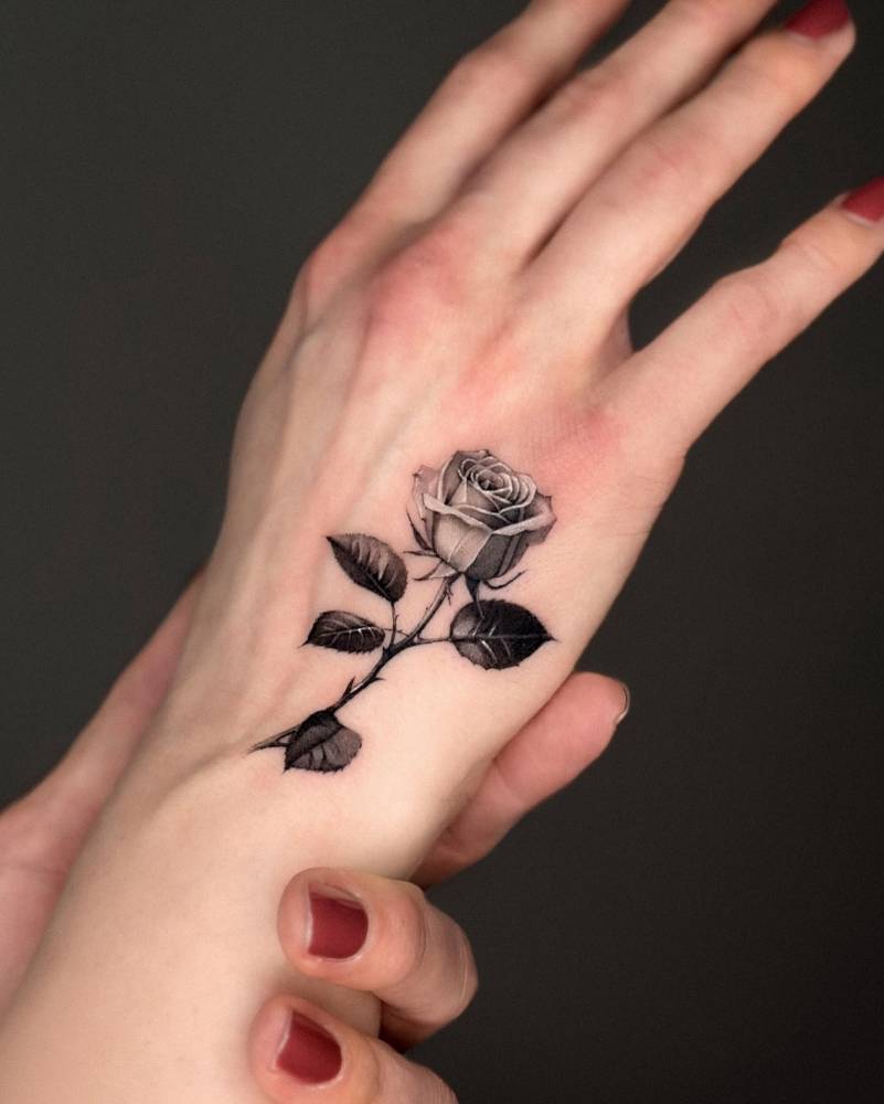 Rose tattoo done on the hand, micro-realistic style.