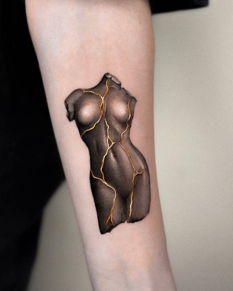 Kintsugi sculpture tattoo located on the inner forearm.