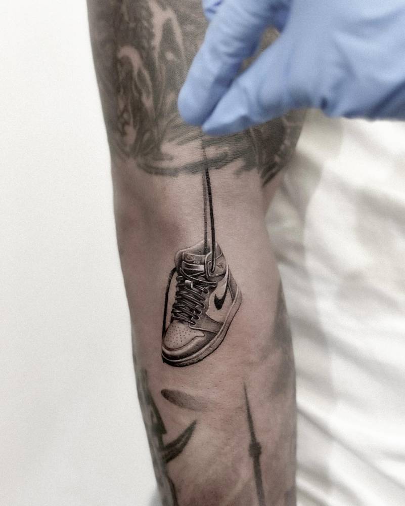 Air Jordan 1 tattoo in micro-realistic style done on the forearm.
