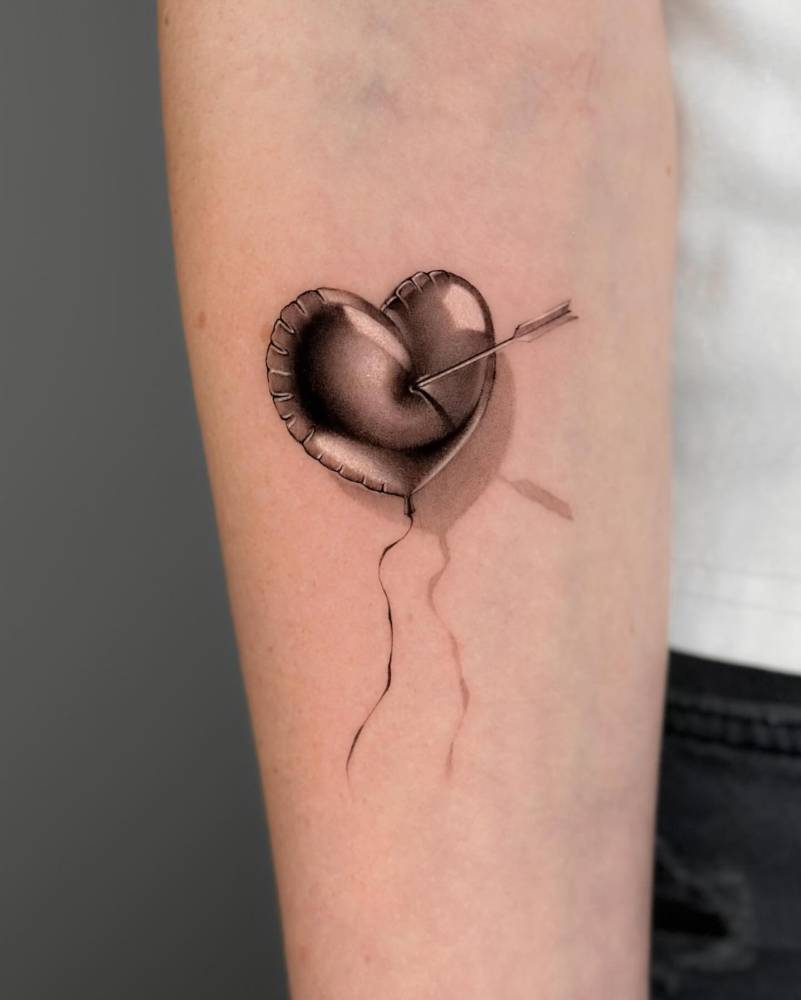 Heart balloon hit by arrow.