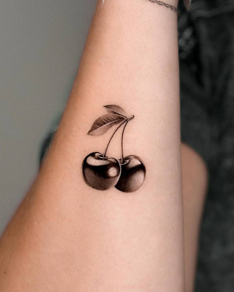 Cherries tattoo in micro-realism located on the wrist.