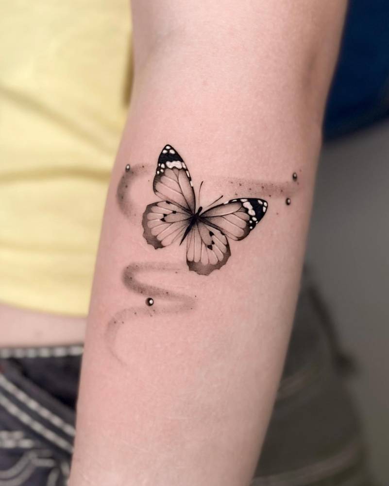 Butterfly tattoo in micro-realistic style done on the forearm.