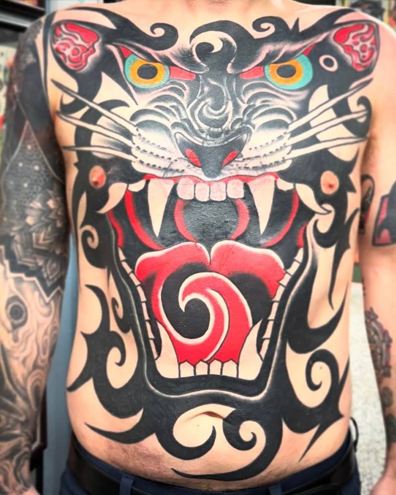 Panther portrait tattoo in traditional style located on the torso.
