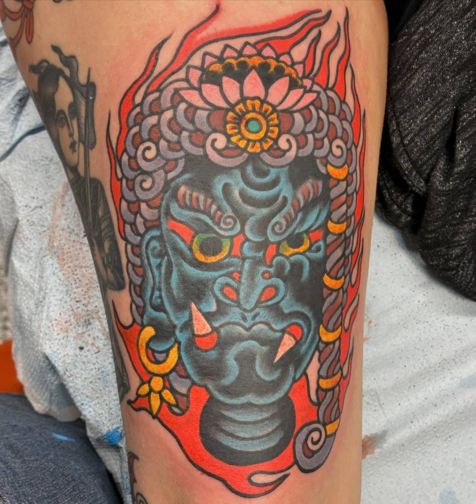 Fudo tattoo in traditional style located on the thigh.