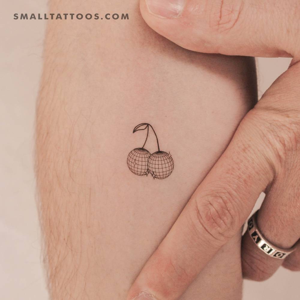 Disco cherries temporary tattoo located on the inner forearm.