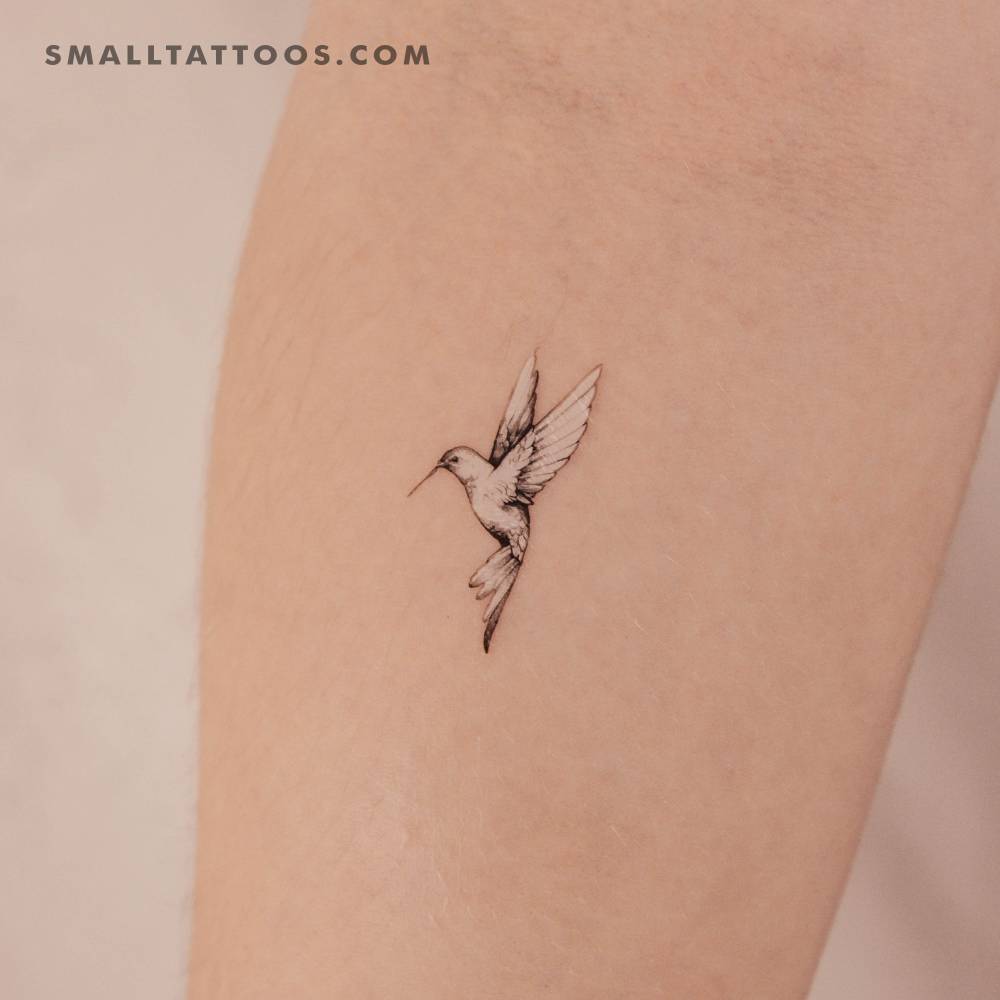 Flying hummingbird temporary tattoo located on the inner forearm.