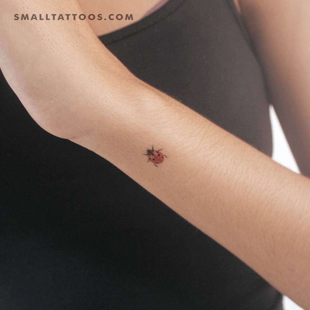 Tiny ladybird temporary tattoo located on the wrist.