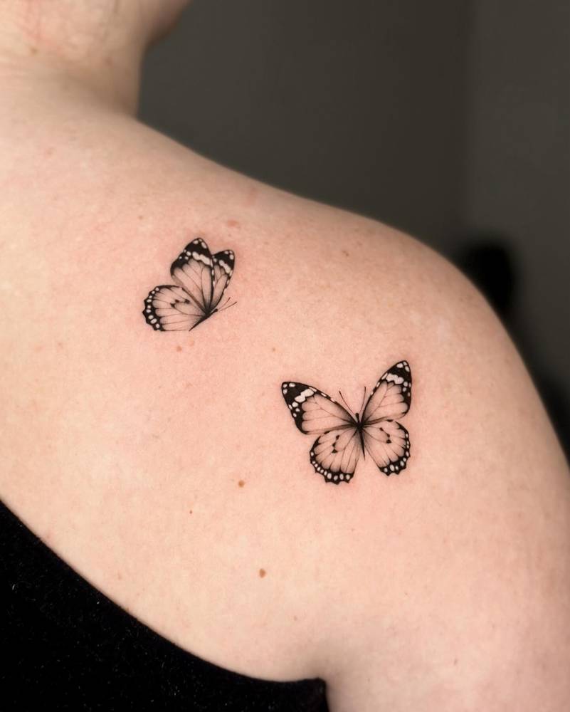 Butterfly couple tattoo in micro-realistic style.