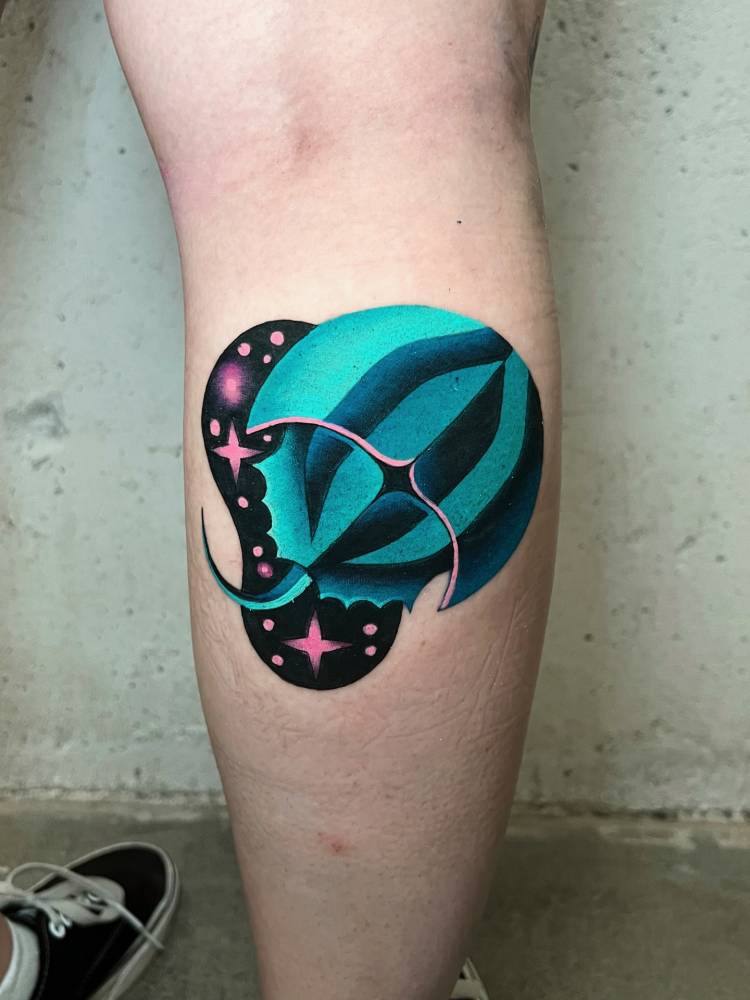 Horseshoe crab tattooed on the calf, done in pop art style.