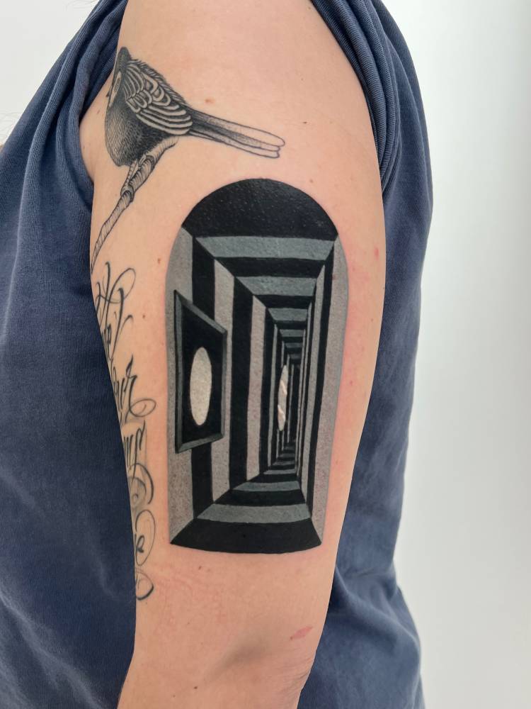 Hallway tattoo located on the upper arm.