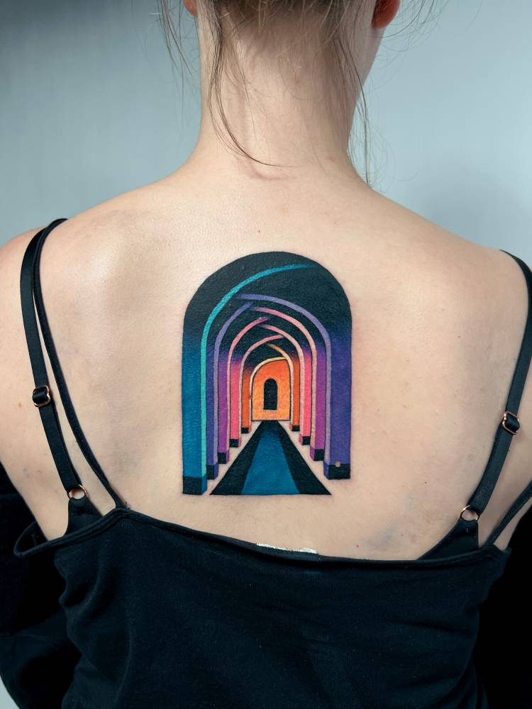 Surrealistic style hallway tattoo located on the upper back.
