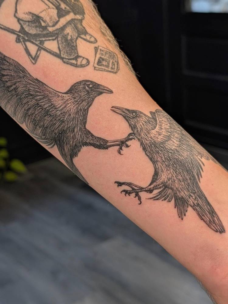 Ravens tattoo located on the inner forearm.