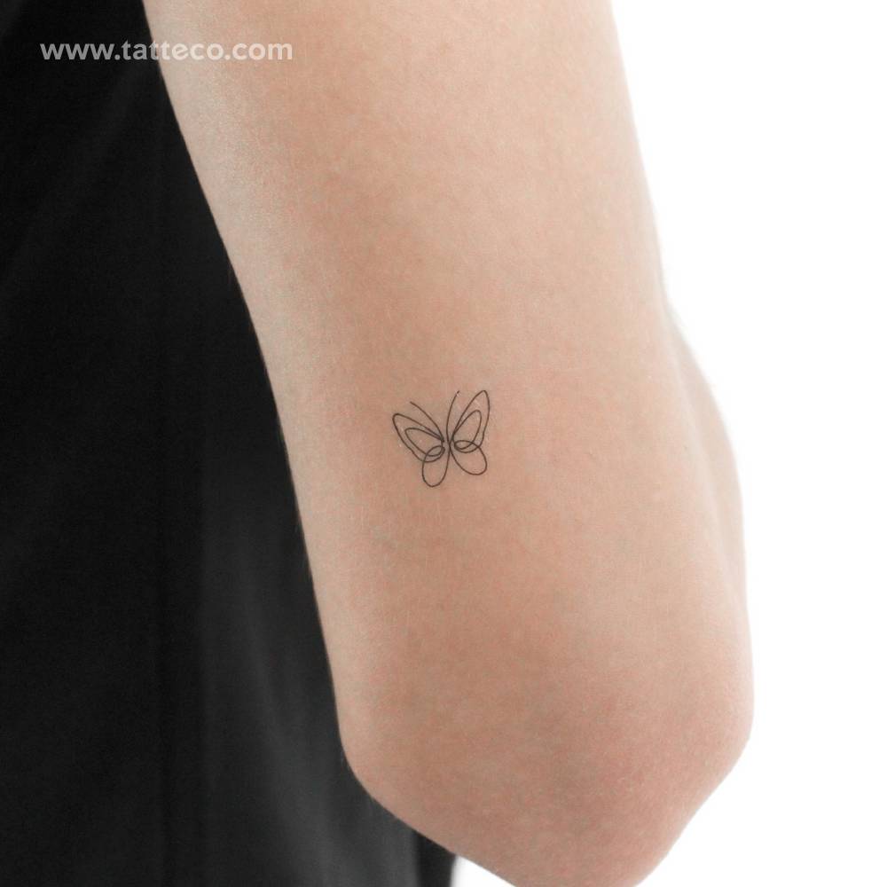 Little single line butterfly temporary tattoo located on the tricep.