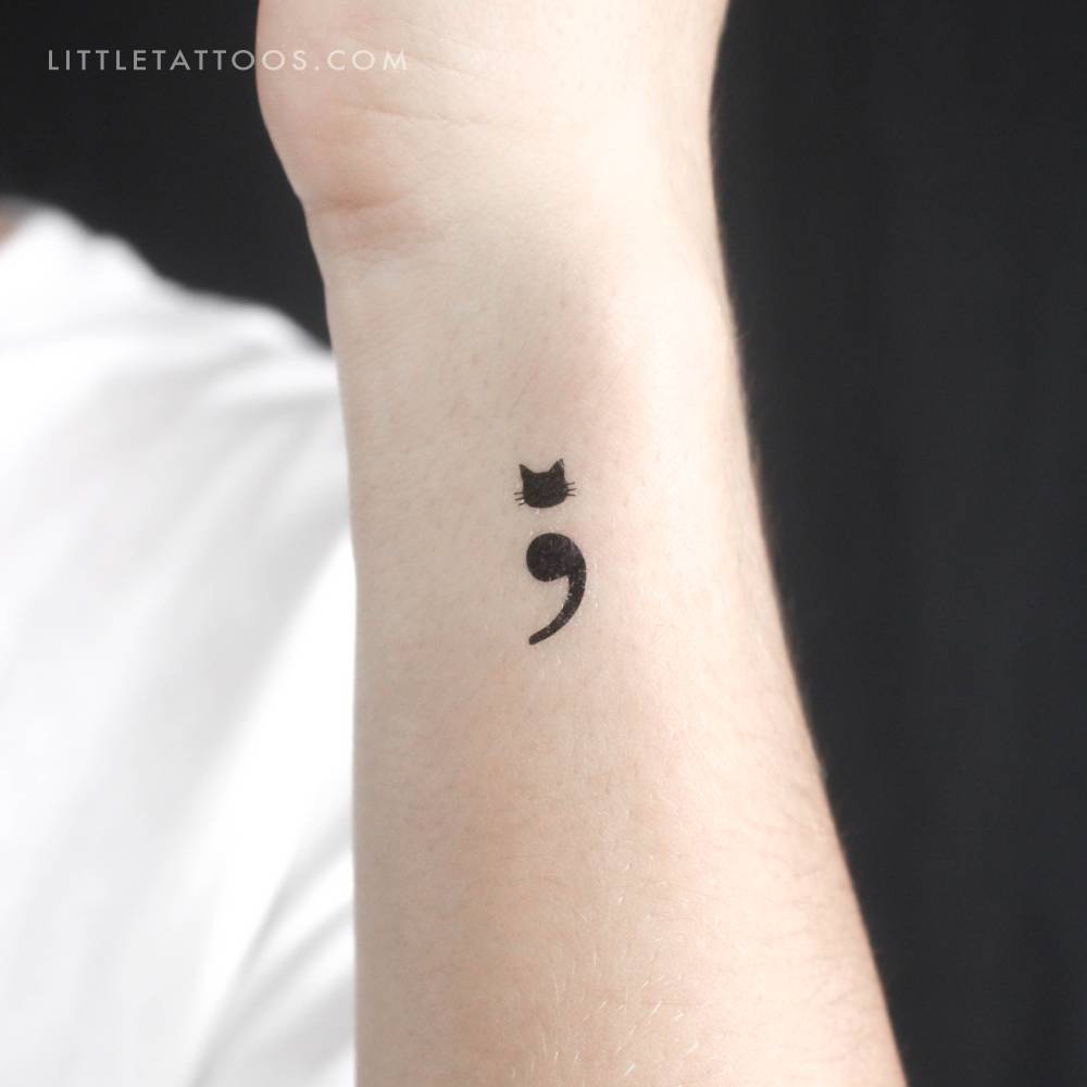 Semicolon cat temporary tattoo located on the wrist.