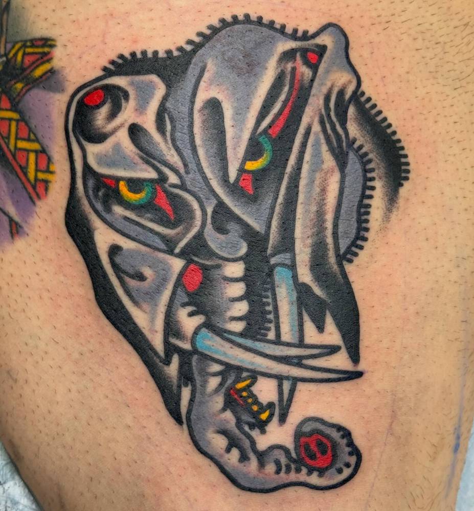 Elephant portrait tattoo placed on the thigh, traditional style.