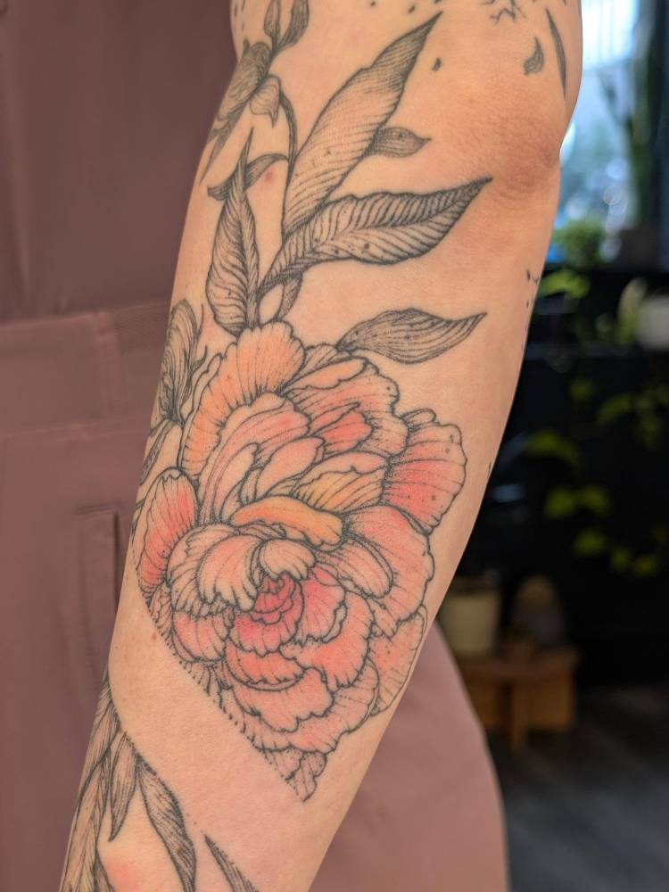 Healed peony tattoo located on the forearm.