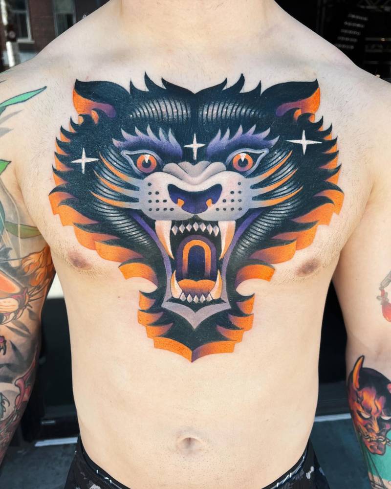 Wolfie head tattoo located on the chest.