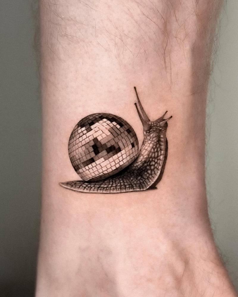 Micro-realistic style cisco snail tattoo located on the wrist.