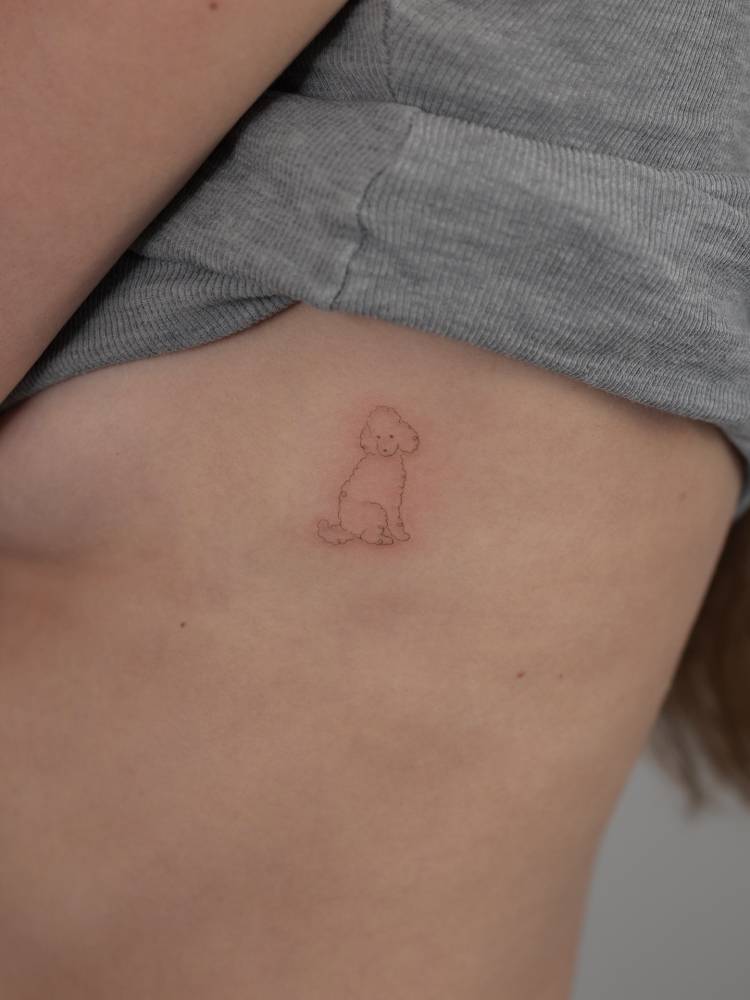 Single needle Poodle tattoo located on the side boob.