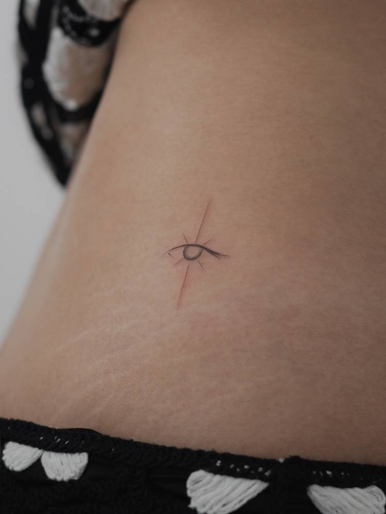 Evil eye tattoo located on the waist.