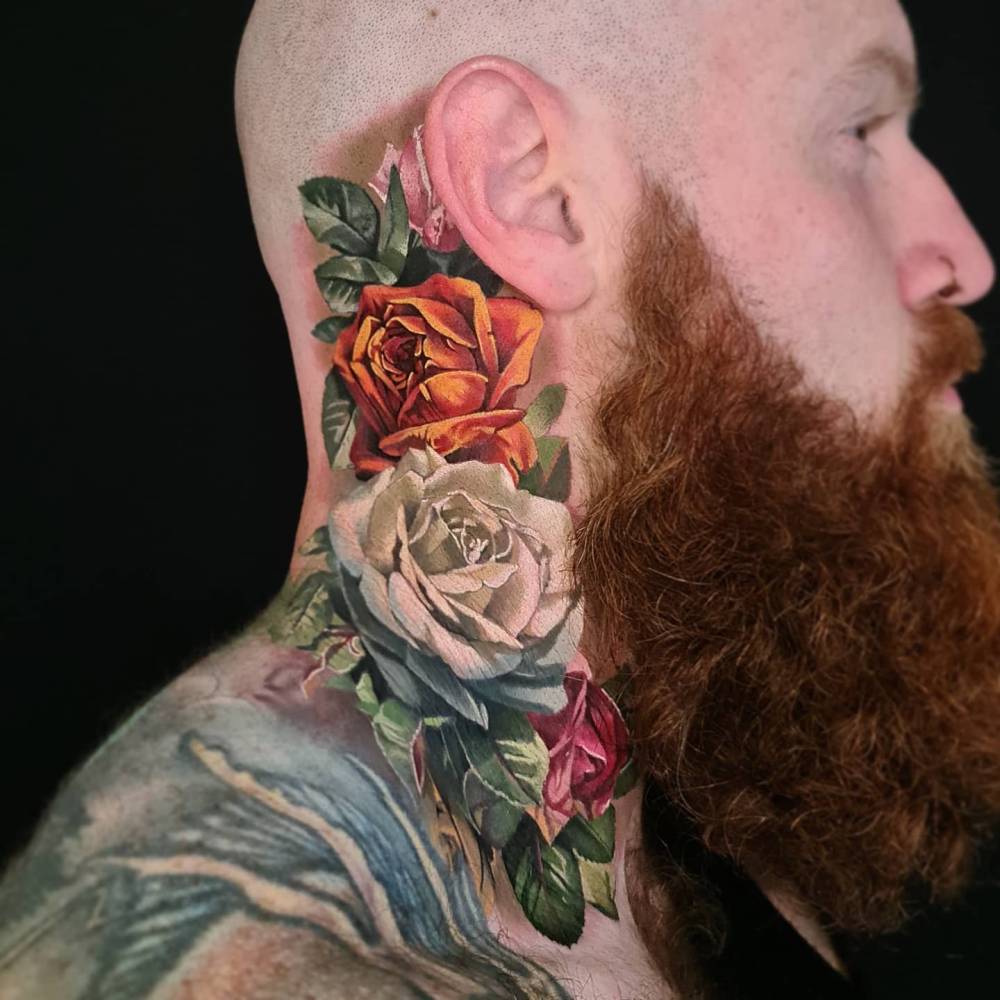 Realistic style roses tattoo located on the neck.