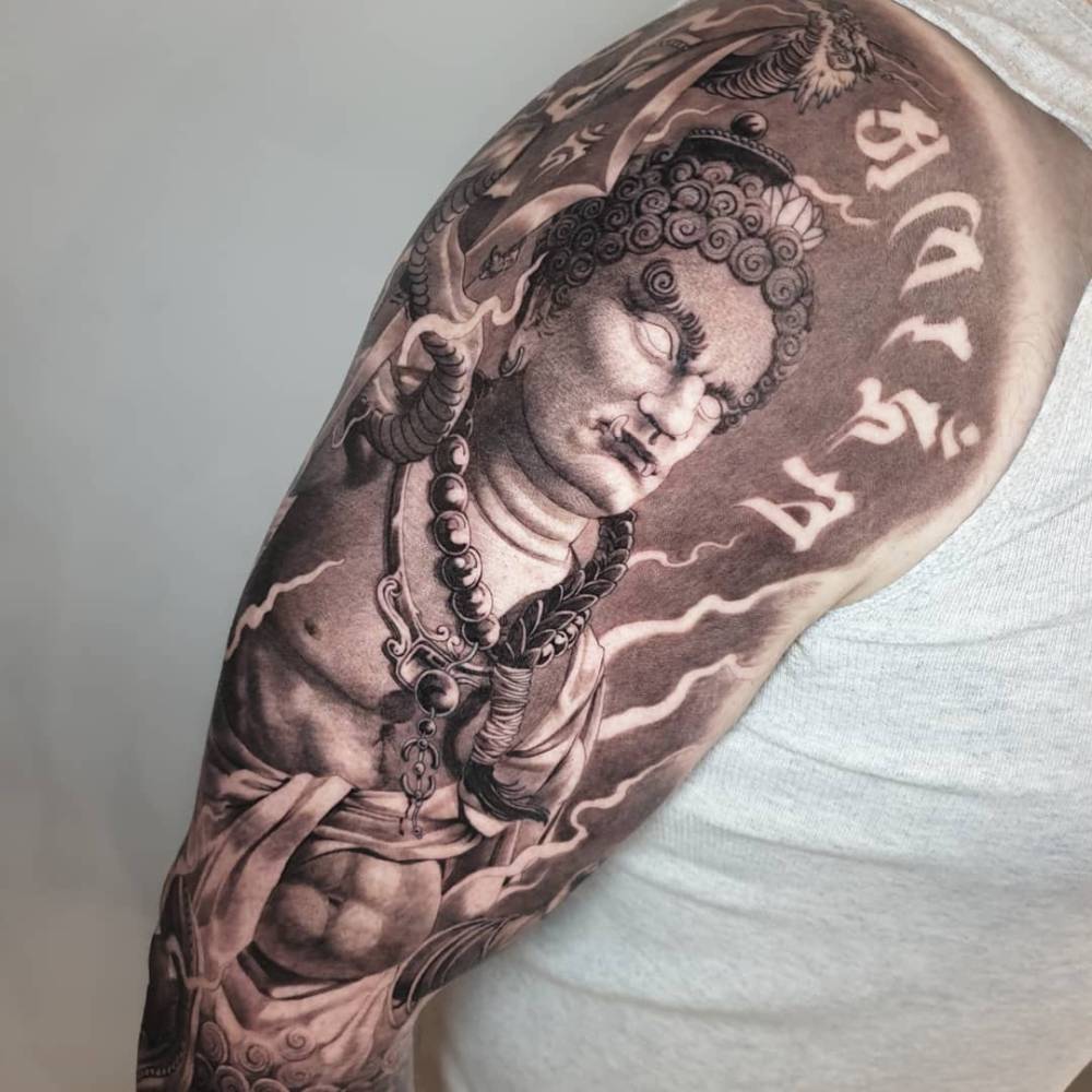 Fudo tattoo in neotraditional style located on the upper arm.