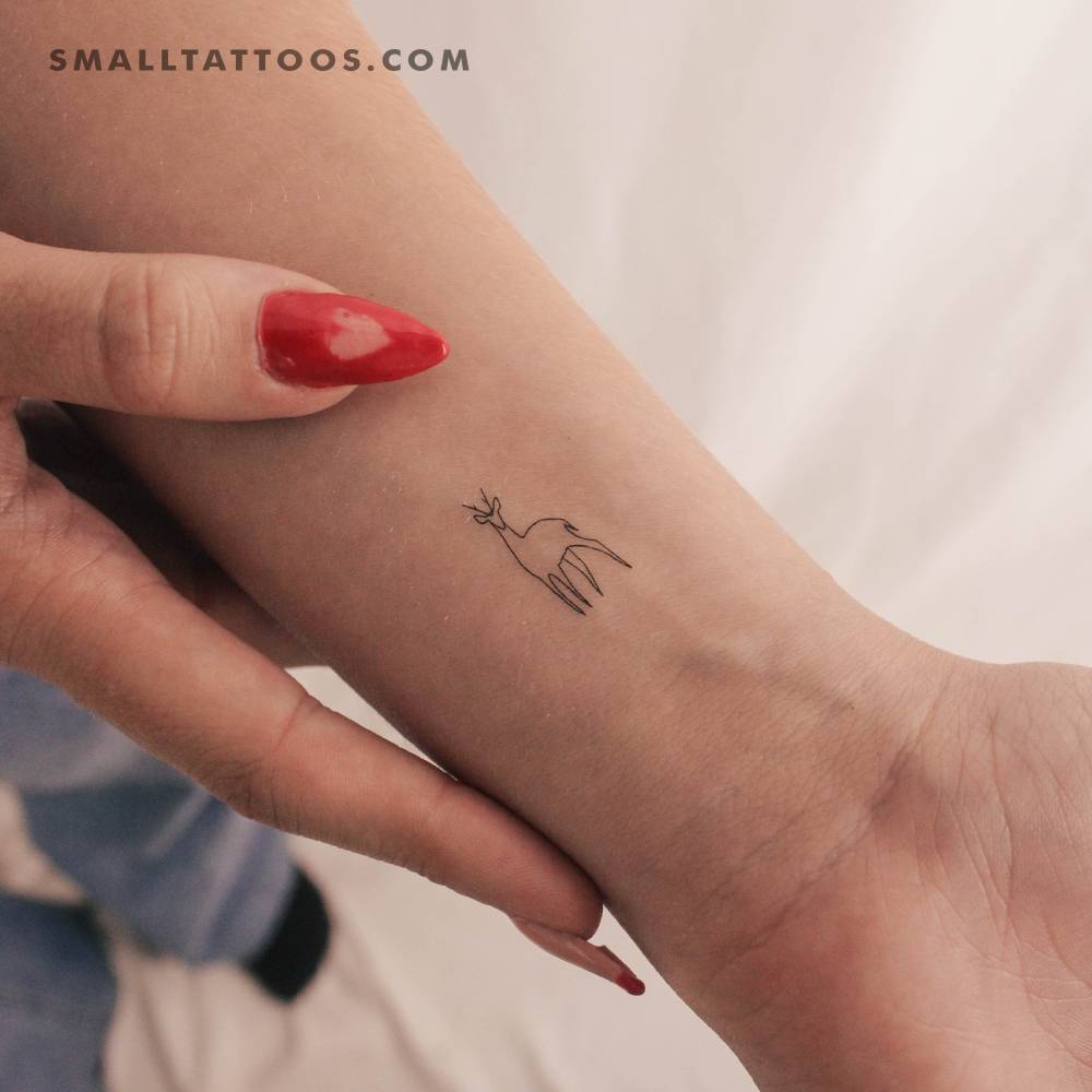 Fine line style little deer temporary tattoo located on the wrist.