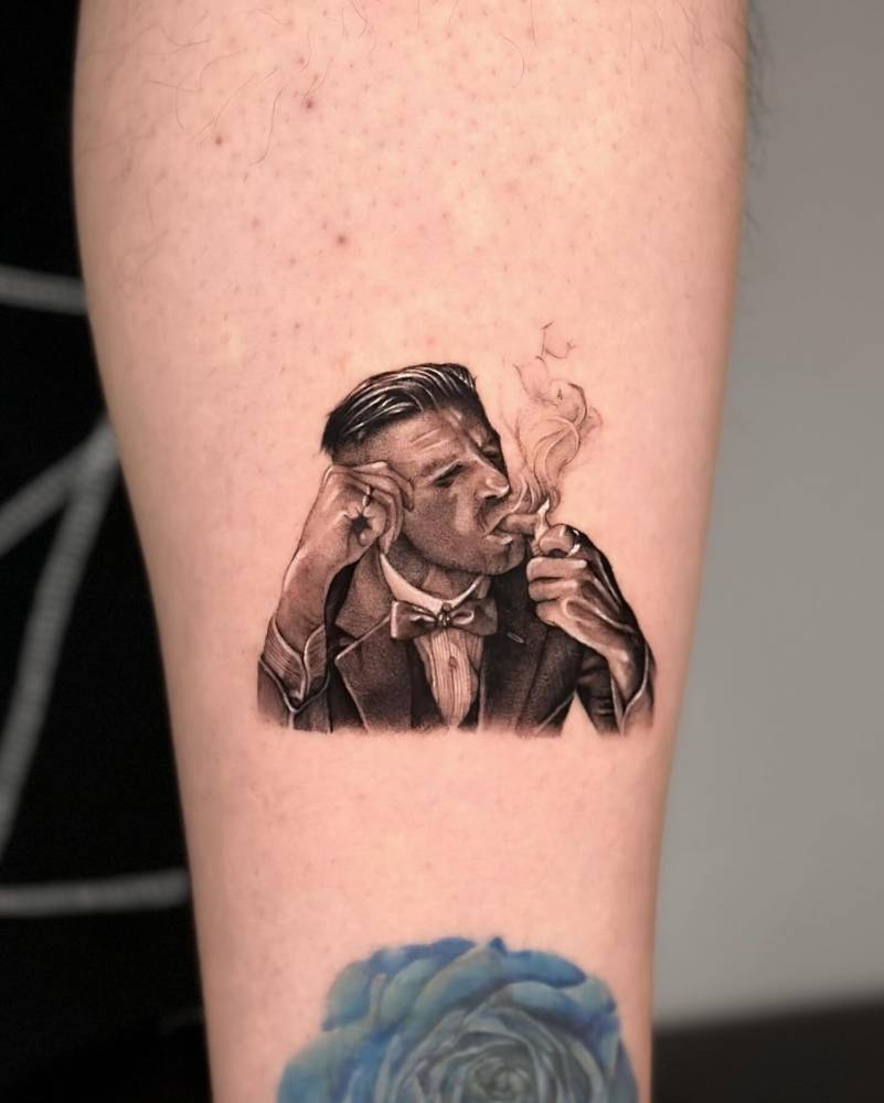 Arthur Shelby portrait tattoo located on the shin.