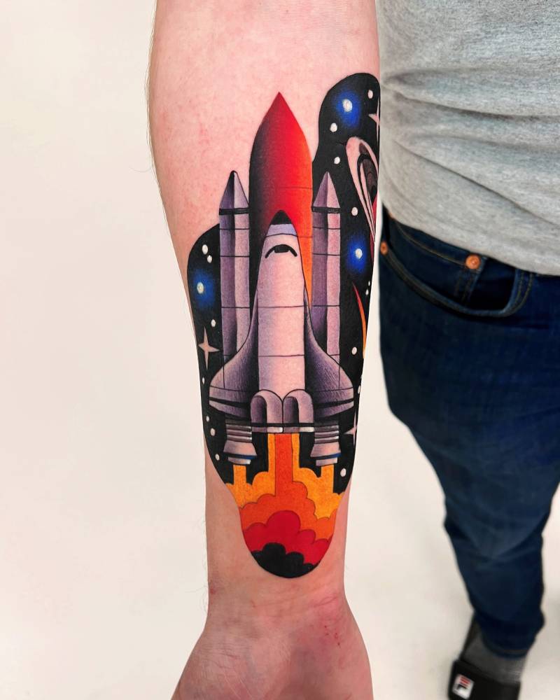 Space shuttle tattoo located on the inner forearm, pop art style.