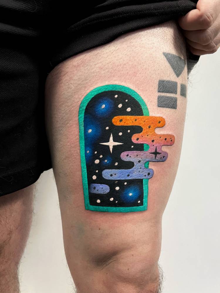 Space window tattoo located on the thigh, pop art style.