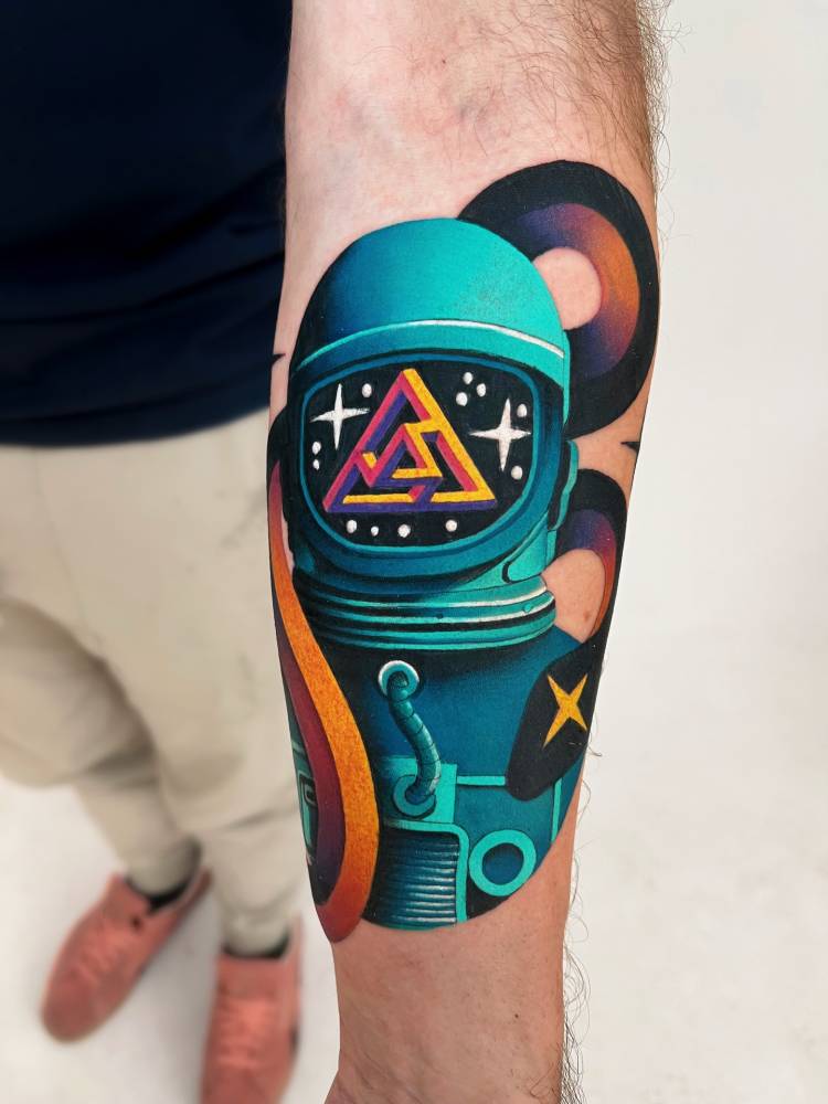 Astronaut tattoo with some snakes and some complex penrose triangle shape thingy in the visor.