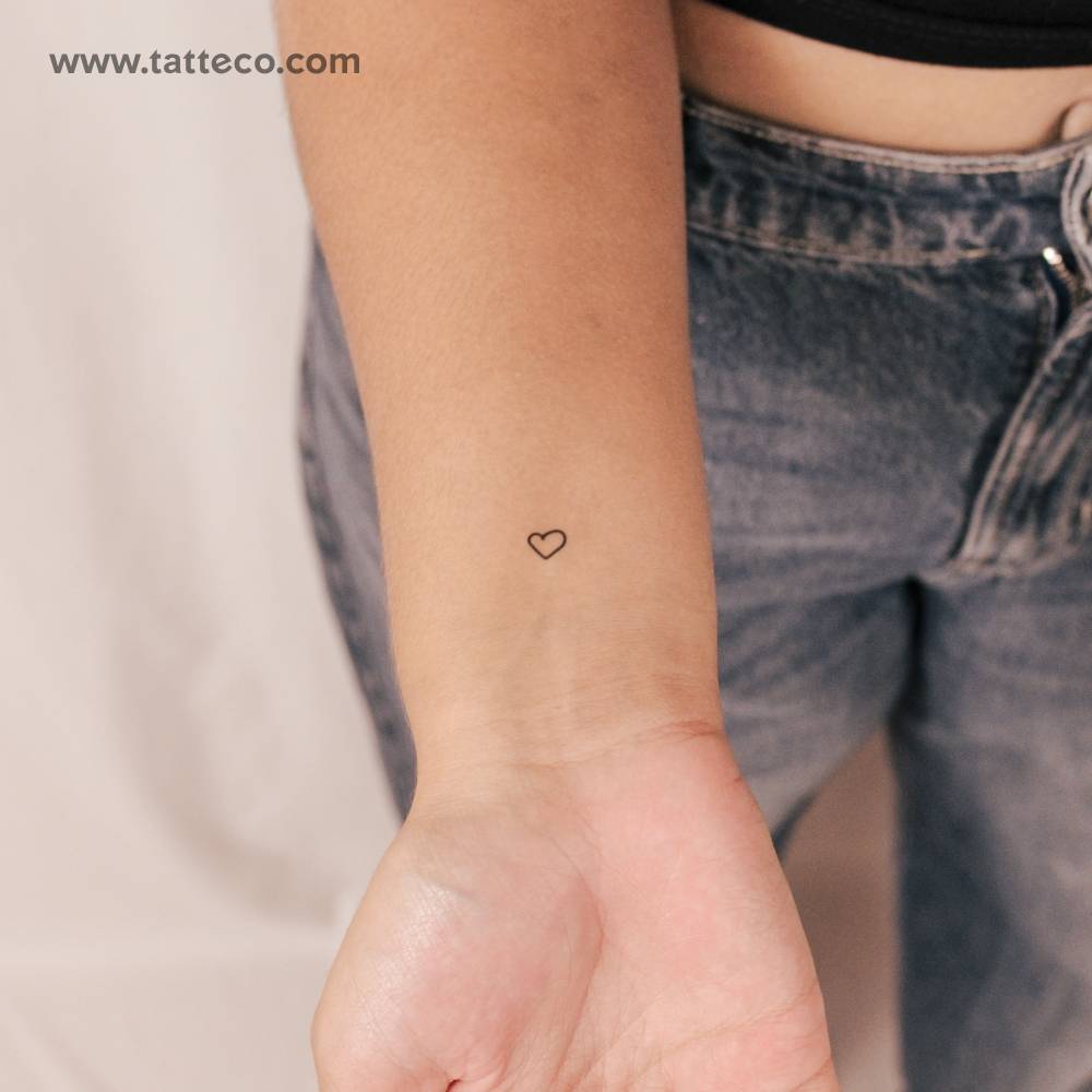 Tiny hand-drawn heart semi-permanent tattoo.
