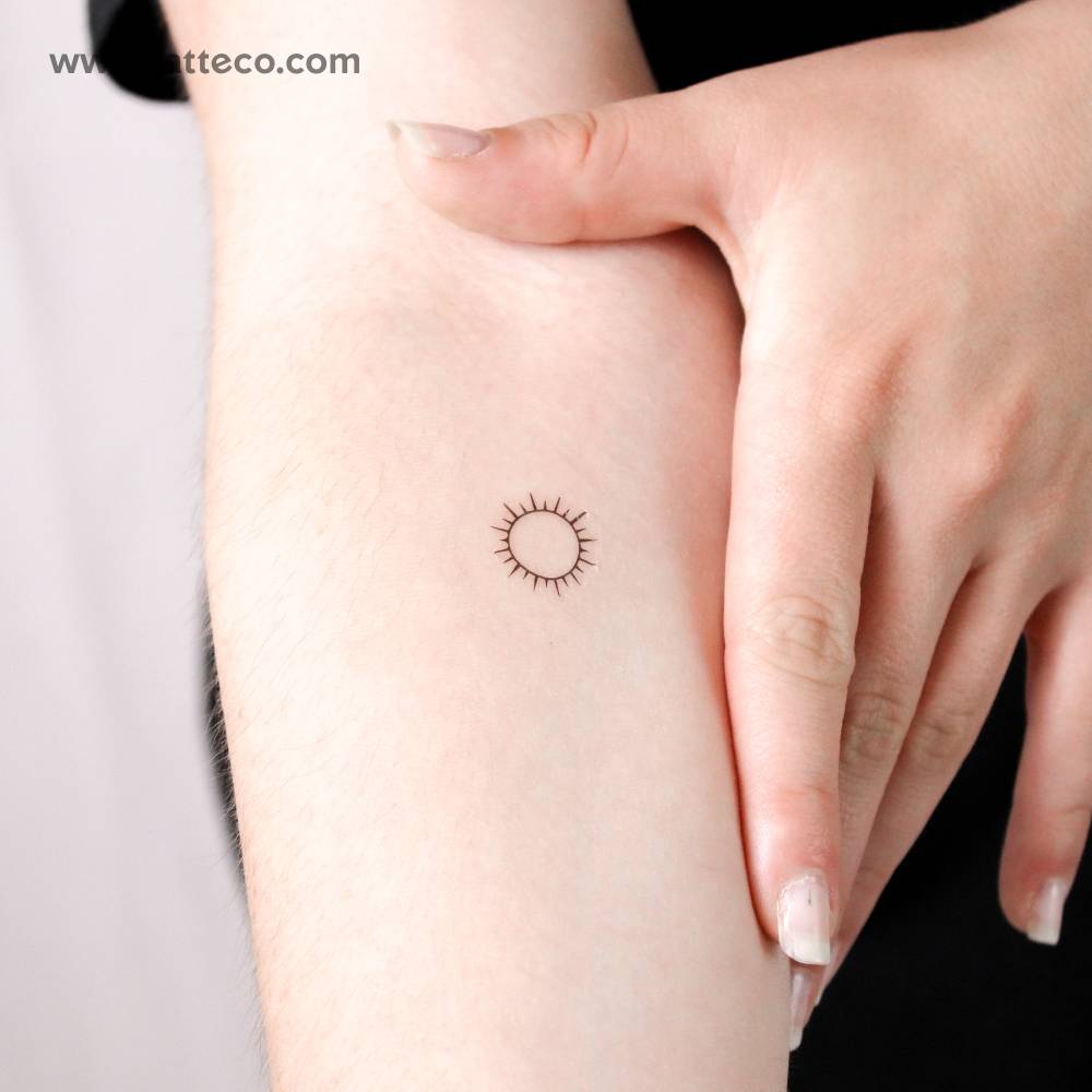 Small shining sun temporary tattoo.