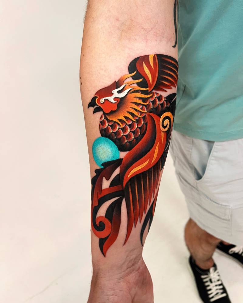 Phoenix tattoo in pop art style located on the inner forearm.