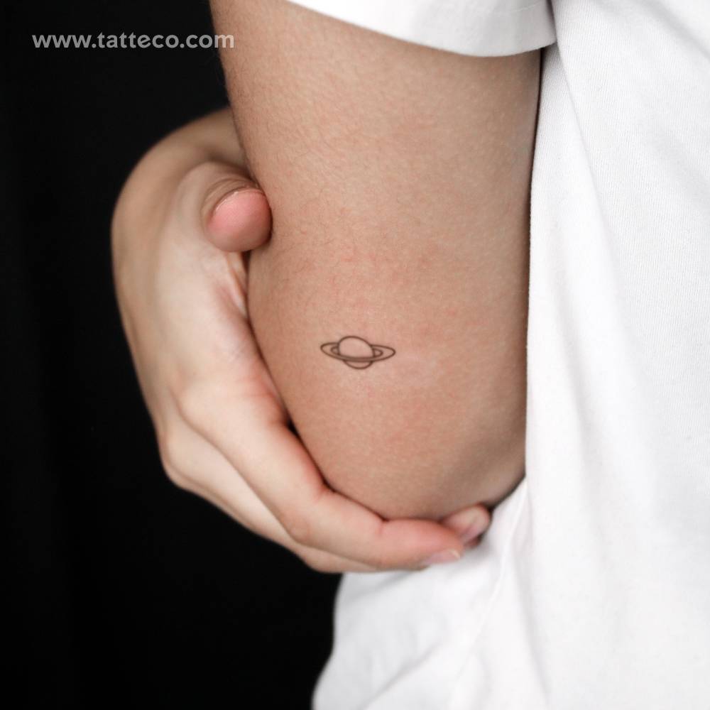 Saturn semi-permanent tattoo located on the tricep.