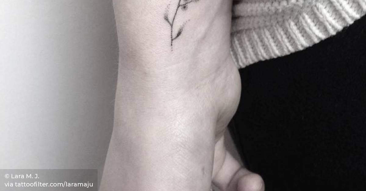 Small hand poked flower tattoo on the right inner