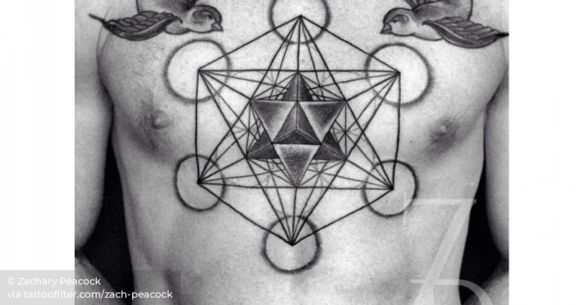 Metatron's cube and merkabah tattoos on the chest.