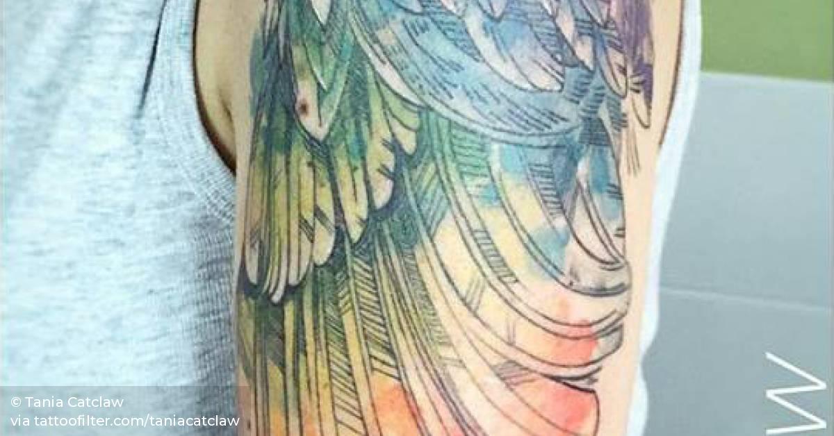 Sketch/watercolor style wing tattoo on the left upper