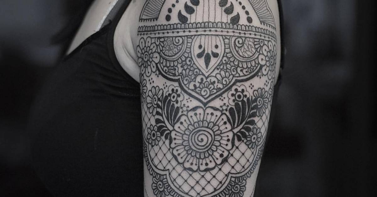 Henna and lace inspired tattoo on the left upper arm