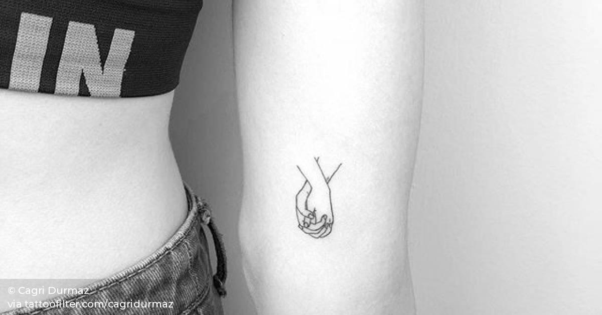 Holding hands tattoo on the left inner arm.
