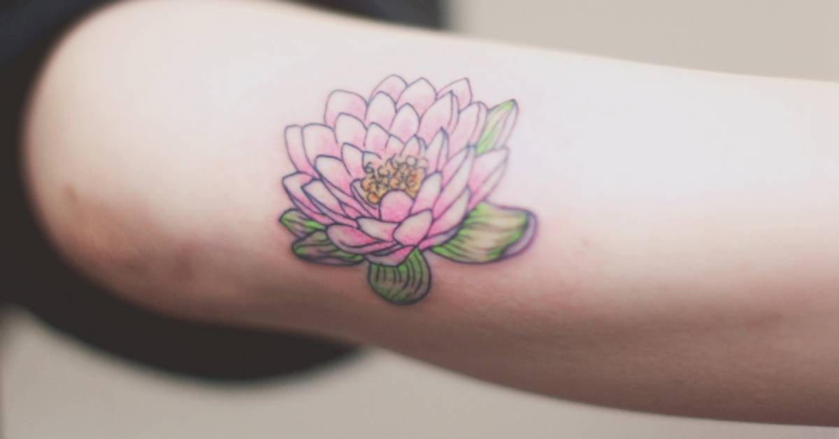 Forearm tattoo of a lotus flower by Seoeon.